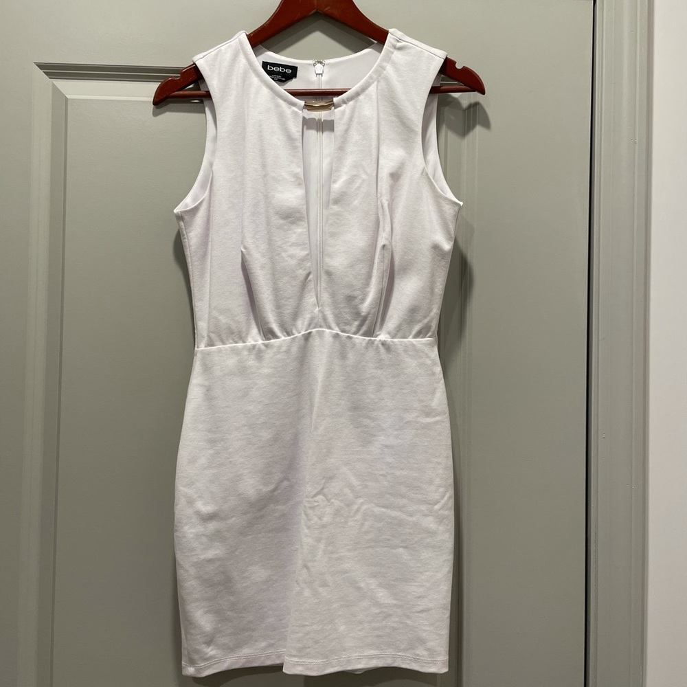 White short dress with slit in chest area.